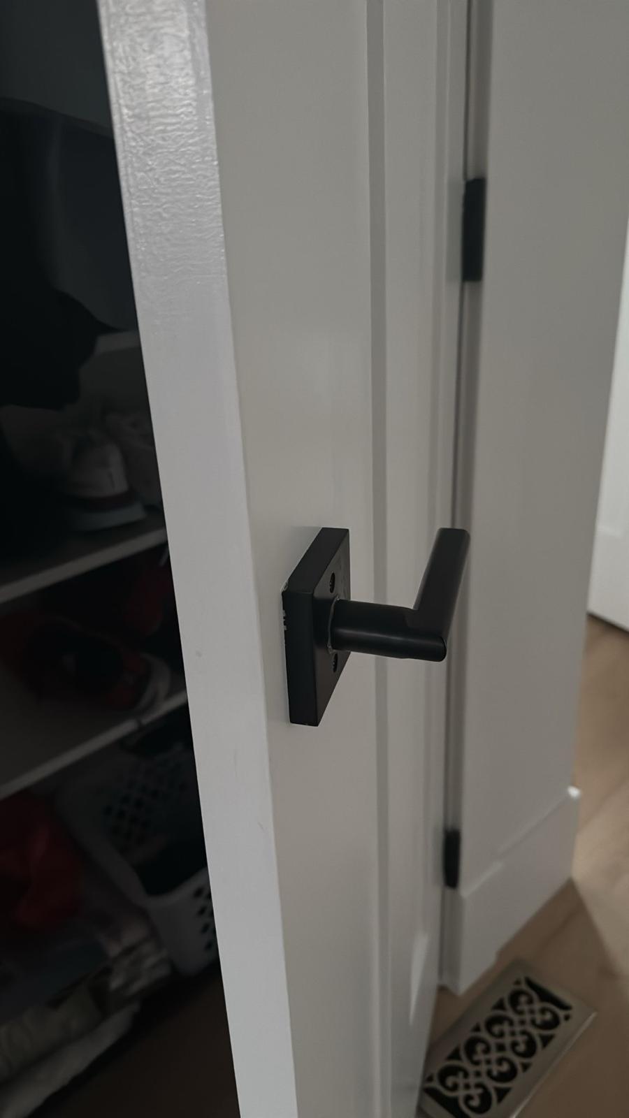 Close-up of fitted matte black door lever hardware