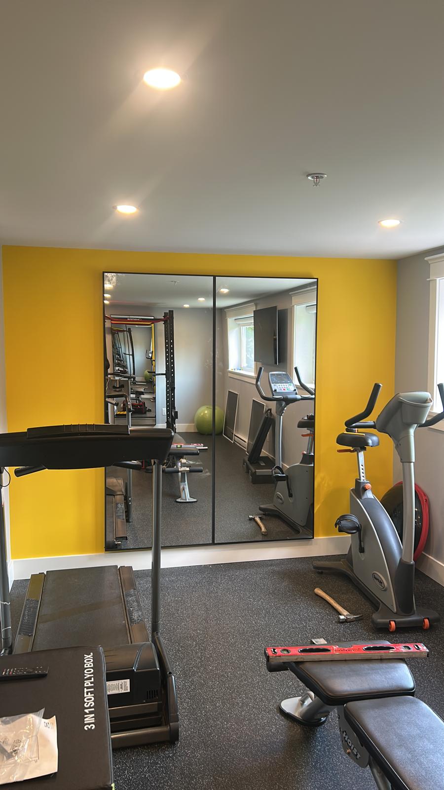 Home gym renovation with accent wall paint and mirror install