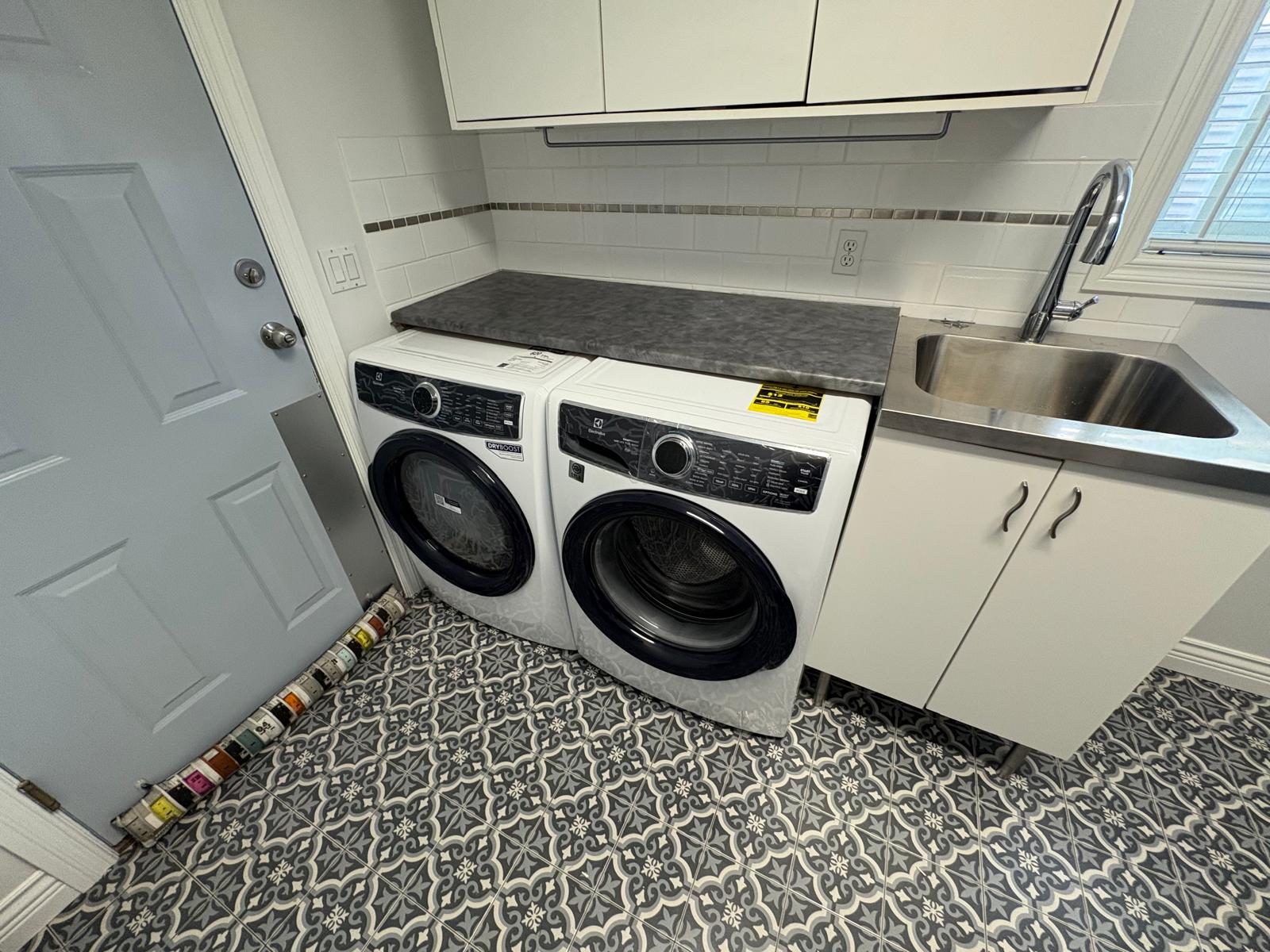 Laundry room renovation with tile and countertop